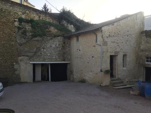 an external view of a brick building with a garage at Maison au carrefour des terroirs in Pouançay
