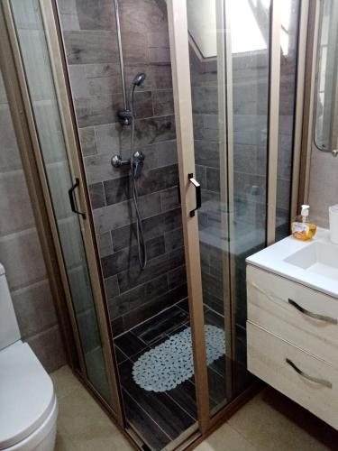 a shower with a glass door in a bathroom at Perla Saidia Appartement in Saïdia