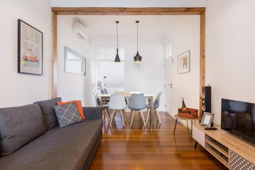 a living room with a couch and a table at Graça and Alfama Heritage 3-BR Signature Suites by NestAtLisbon in Lisbon