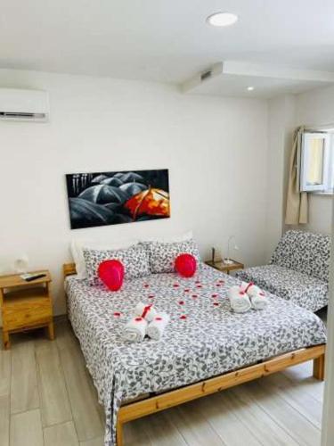 a bedroom with a bed with red balls on it at Il Daviduccio Suite in Siracusa