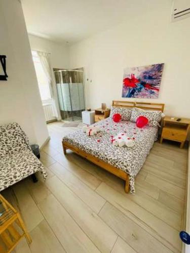 a bedroom with a bed with red pillows on it at Il Daviduccio Suite in Siracusa