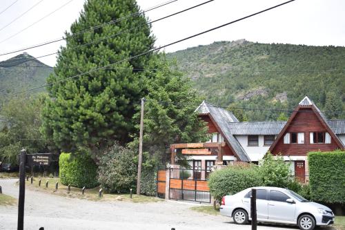 a white car parked in front of a house at Villa San Ignacio in San Carlos de Bariloche