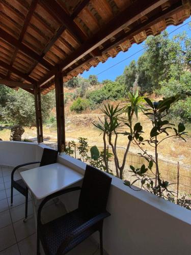 a table and chairs on a balcony with a view at Archontika Apartments in Kerames