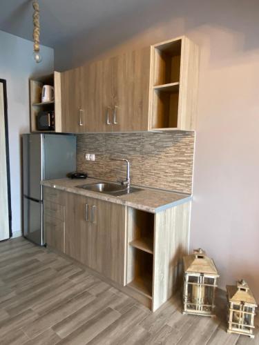 a kitchen with a sink and a refrigerator at Vot villas in Ormos Panagias