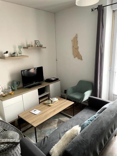 un salon avec un canapé et une table dans l'établissement Appartement Rue de la gare centre ville, à Quiberon