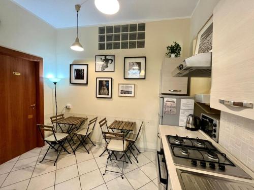 a kitchen with a table and chairs and a stove at SanGregoRooms in Naples