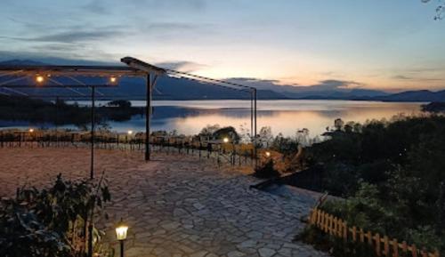a view of a body of water at night at Ξενώνας Παρατηρητήριο Υπερώον in Ágios Athanásios