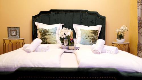 a bedroom with a bed with white sheets and flowers at pensiunea medellin in Tulcea