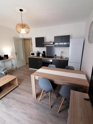 a kitchen with a large wooden table and chairs at L'ESCALE DETENTE EN VERCORS in Saint-Jean-en-Royans