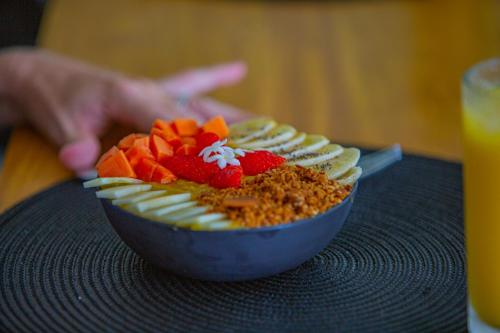 a bowl of food with strawberries and rice on a table at Villa Vanna in Unawatuna