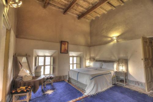 A bed or beds in a room at Kasbah Baha Baha