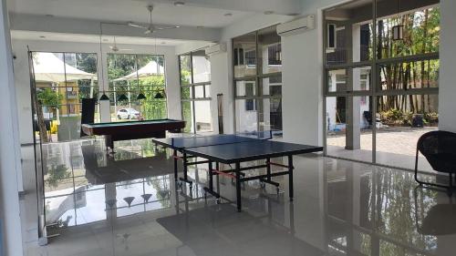a dining room with a table and a piano at 3 Bedroom Apartment, Ariyana Resort in Athurugiriya
