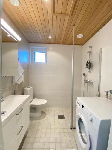 a bathroom with a washer and dryer in it at Skyview apartment Kalajoki Hiekkasärkät in Kalajoki