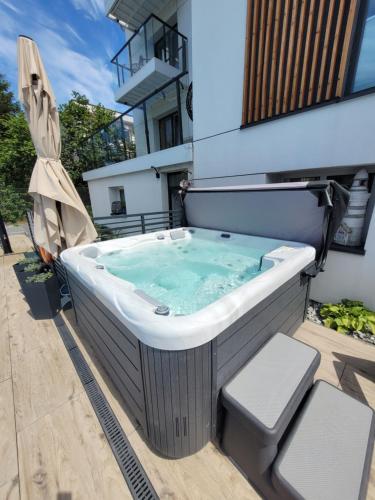 a hot tub on the balcony of a building at Apartamenty Dolce Vita in Ostrowo