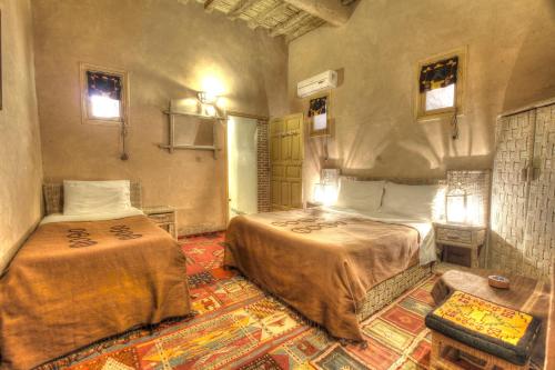 A bed or beds in a room at Kasbah Baha Baha