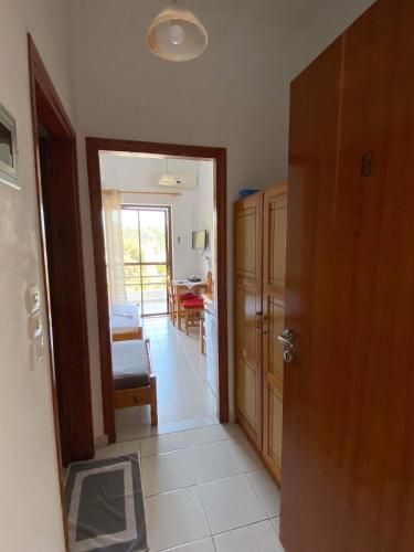 a hallway with a door leading to a living room at Archontika Apartments in Kerames