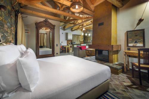 a bedroom with a large bed and a fireplace at Montanema Handmade Village in Platanákos