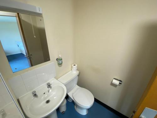 a bathroom with a white toilet and a sink at Waterfront Lodge - Accommodation Only in Fort William