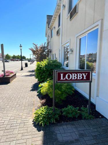 a sign that says lobby in front of a building at Court Plaza Inn & Suites of Mackinaw in Mackinaw City