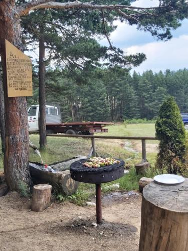 a grill with food in it next to a tree at Apartment Krasi in Velingrad