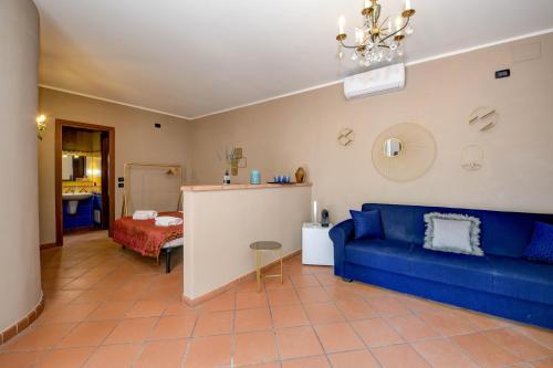 a living room with a blue couch and a table at Prestige rooms in Sirmione