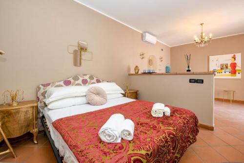 a bedroom with a bed with towels on it at Prestige rooms in Sirmione