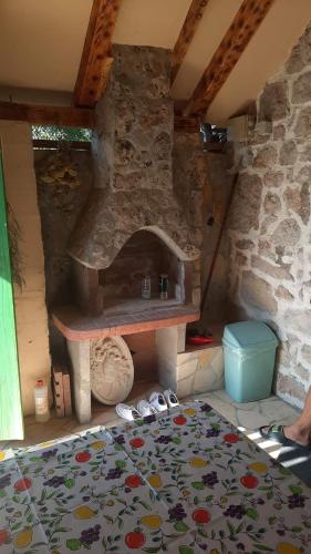 a room with a stone oven with shoes on the floor at Olivia in Starigrad