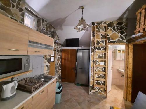 a kitchen with a sink and a counter with a refrigerator at Olivia in Starigrad-Paklenica