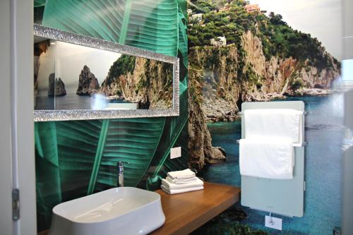 a bathroom with a wall mural of a river at Room Capri in SantʼAntonio Abate