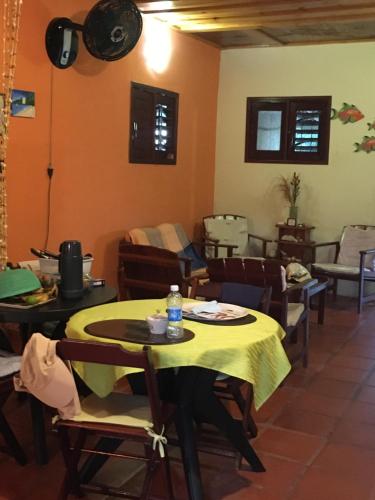 a dining room with a table and chairs at Casa na Praia de Muriu - Andréia in Muriú