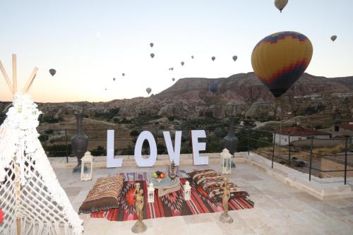 a sign that says love and a hot air balloon at Underground Cave Suites Hotel in Goreme
