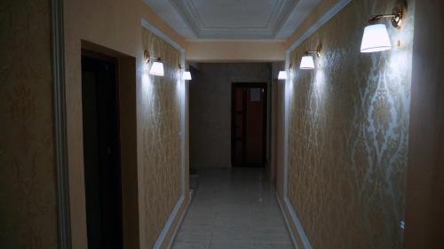 a hallway with two lights on the walls of a building at pensiunea medellin in Tulcea