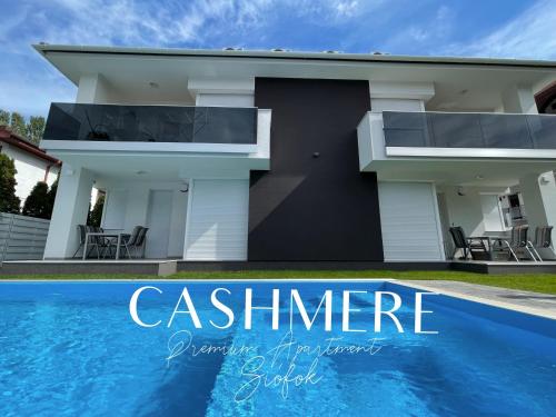 a house with a swimming pool in front of it at CASHMERE Premium Apartment in Siófok