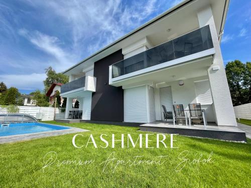 a villa with a swimming pool and a house at CASHMERE Premium Apartment in Siófok