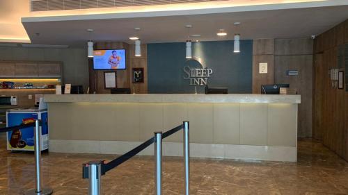 a check in counter in a hotel lobby at Sleep Inn Praia do Canto in Vitória