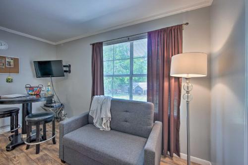 a living room with a chair and a table and a window at Cozy Studio Cabin on Lake O the Pines with Deck! in Avinger