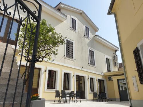 a building with chairs and tables in a courtyard at Kotor Center W in Kotor