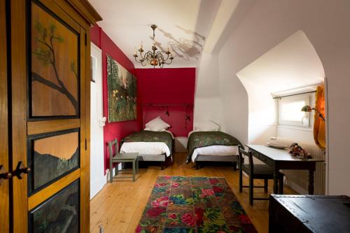 a room with two beds and a desk in it at Le Clos d'Azel MAISON D'HOTES in Flexbourg