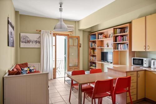 a kitchen and dining room with a table and chairs at La Casetta in Argostoli