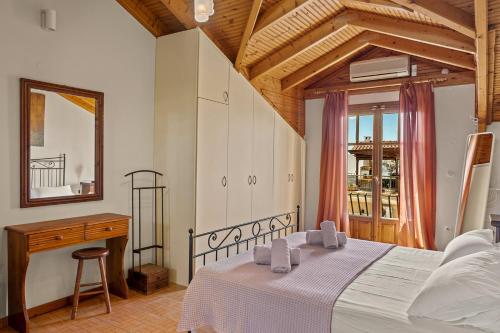a bedroom with a bed and a desk and a mirror at La Casetta in Argostoli