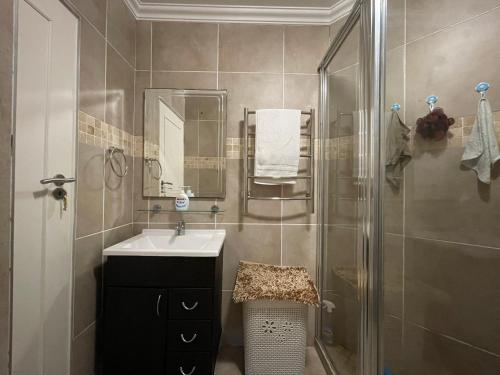 a bathroom with a sink and a shower at Beachfront @ Driftwood 6 Luxury Family Apartment in Ballito