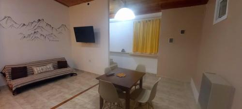 a living room with a couch and a table at Paraíso Ushuaia in Ushuaia