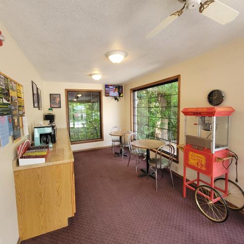 a room with a desk and a table with a bike in it at Candlewick Inn and Suites in Eureka Springs