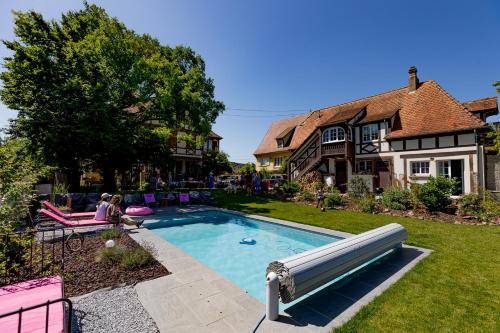 a pool in the yard of a house at Le Clos d'Azel MAISON D'HOTES in Flexbourg