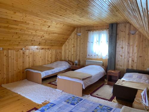 a room with three beds in a wooden cabin at Žabljak Getaway Rental in Žabljak