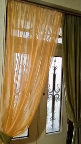 a window with curtains and a cross on it at Royal Boutique Hotel on Kievyan in Yerevan