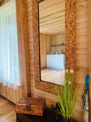 a mirror on the wall of a sauna at Sea Side Kaltene in Kaltene