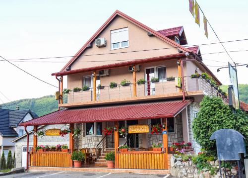 ein Haus mit Blumen auf der Vorderseite in der Unterkunft Restoran & Motel Manjež in Bijelo Polje