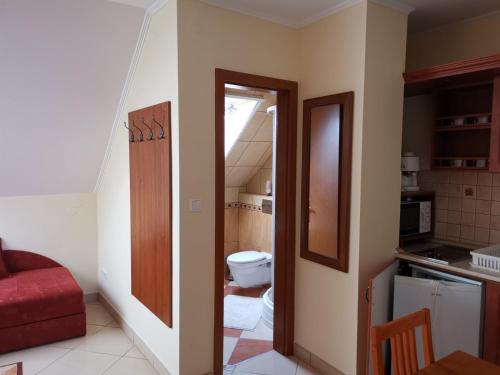 an open door to a bathroom with a toilet at Harmónia Panzió in Sárospatak