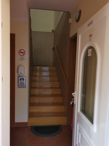 a hallway with stairs in a building at Harmónia Panzió in Sárospatak